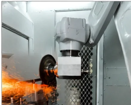Automated grinding machine fettling a casting with sparks