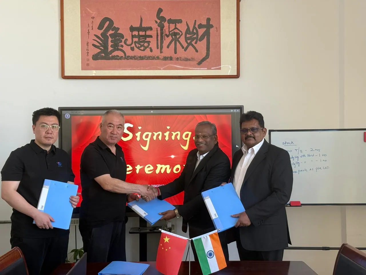 WEWIN Unique and Qingdao Huacan leaders shake hands at the partnership signing ceremony